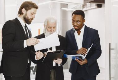 Professional advisers reviewing documents together, the kind of advisory work professional indemnity insurance protects