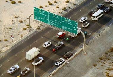 Cars on a UAE road, illustrating the choice between TPL and comprehensive car insurance