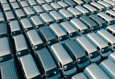 Row of commercial vans parked together, representing fleet motor insurance for UAE businesses