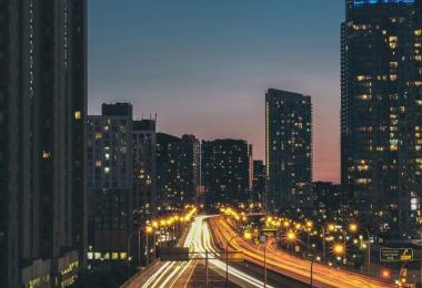 City highway traffic at dusk, illustrating car insurance in the UAE