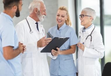 Doctors and nurses reviewing a patient plan, illustrating health insurance in the UAE